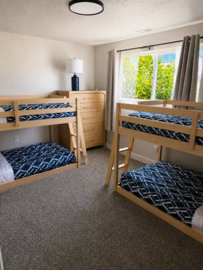 Bedroom with double bunk beds and blue patterned bedding