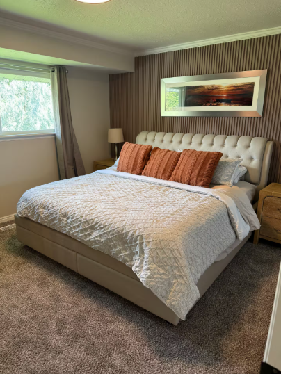 Master bedroom with tufted upholstered headboard and matching nightstands