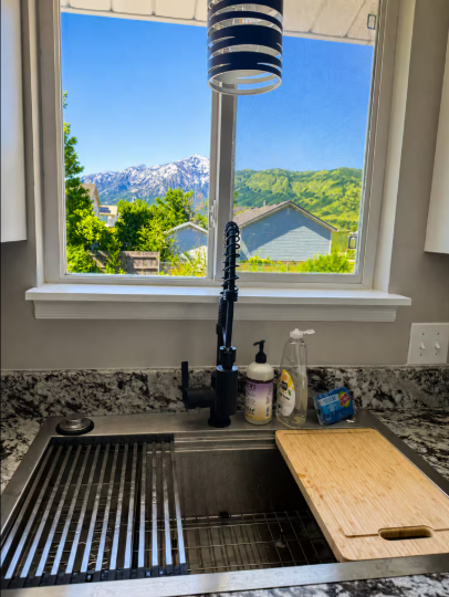 Kitchen sink with stunning snow-capped mountain views through the window