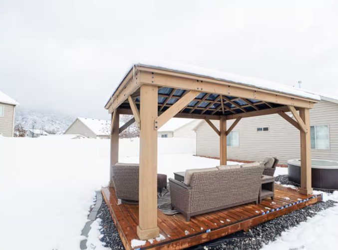 12x16 covered gazebo with outdoor seating on wood deck surrounded by snow and mountain views