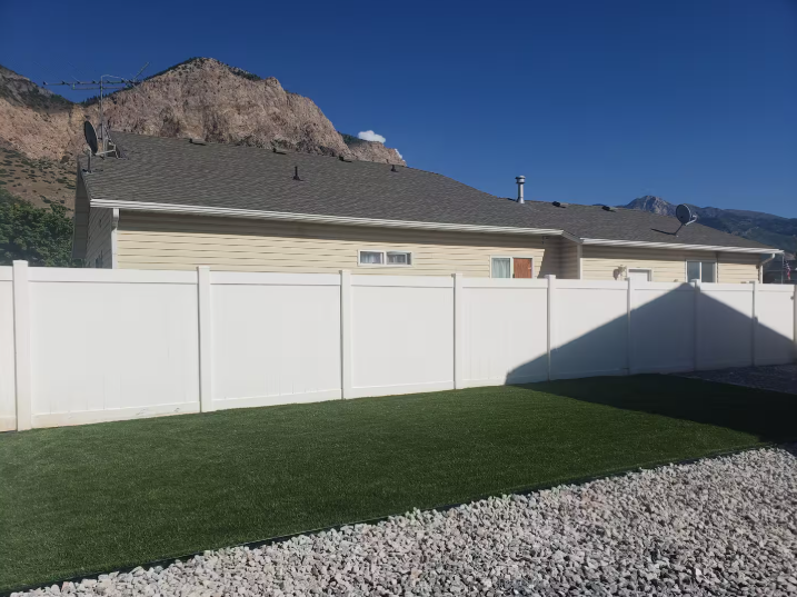 Large fully fenced backyard with artificial turf lawn and stunning Wasatch Mountain views