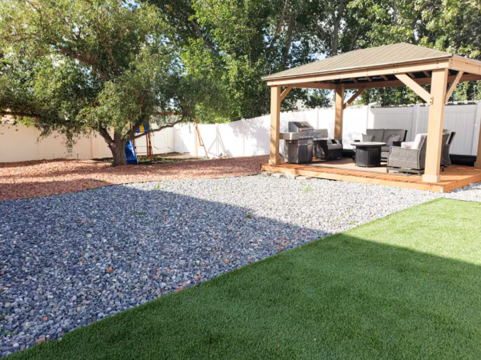 Private hot tub in fenced backyard with mountain views