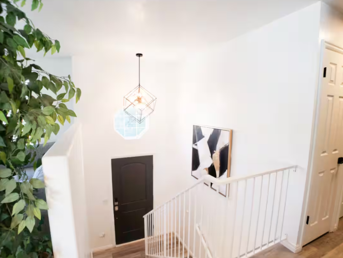 Fully equipped kitchen with white cabinets, stainless steel appliances and breakfast bar