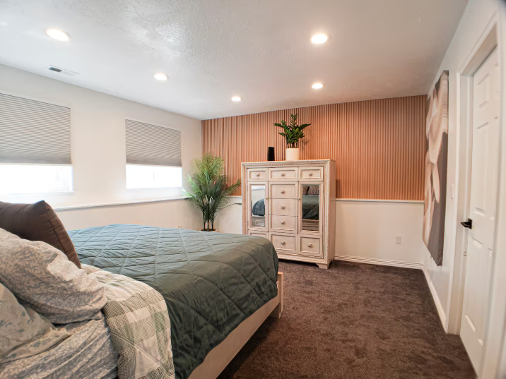 Bright remodeled kitchen with white cabinets, granite countertop breakfast bar, stainless steel appliances and pink orchid