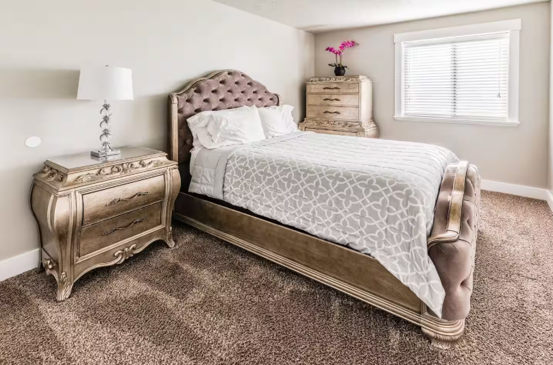 Spacious bedroom with tufted headboard and natural light