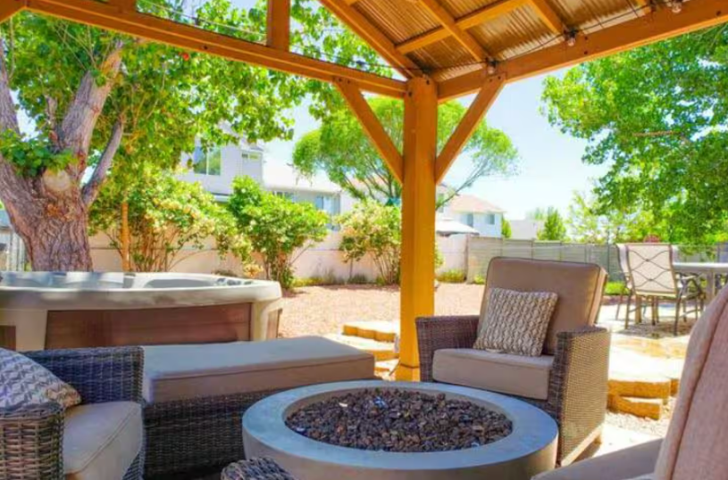 Backyard wooden pergola with fire pit seating area and outdoor furniture