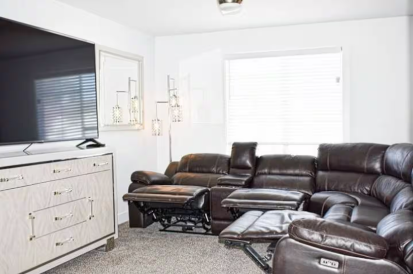 Living room with leather power recliners and large flat-screen TV