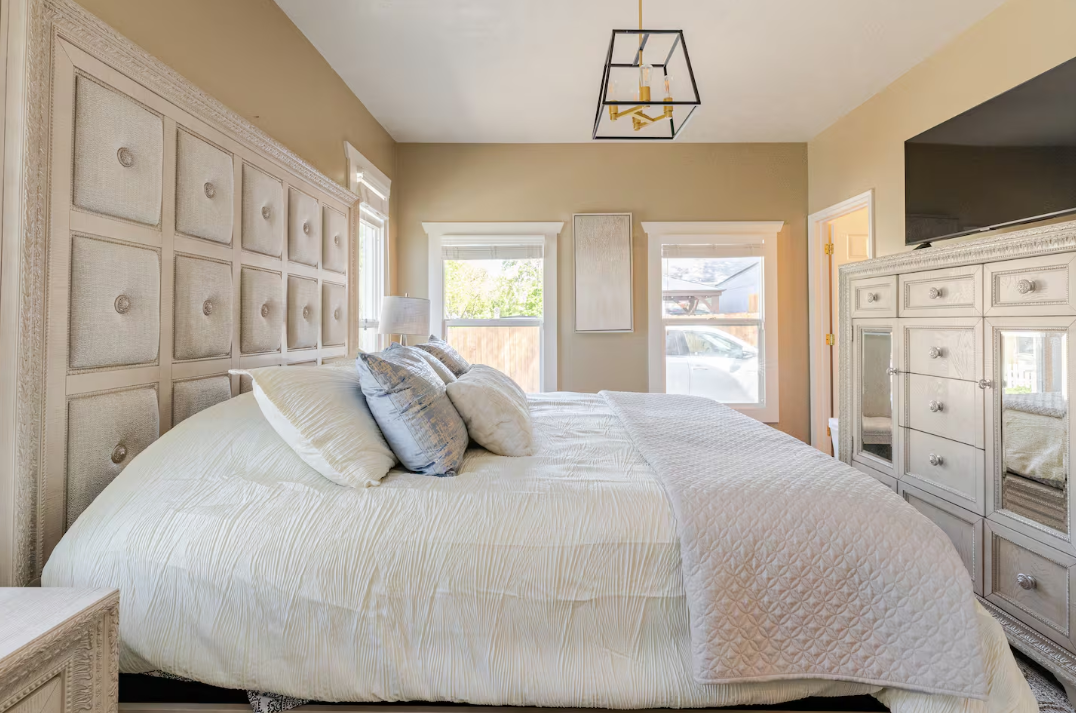 Guest bedroom with queen bed and neutral modern decor
