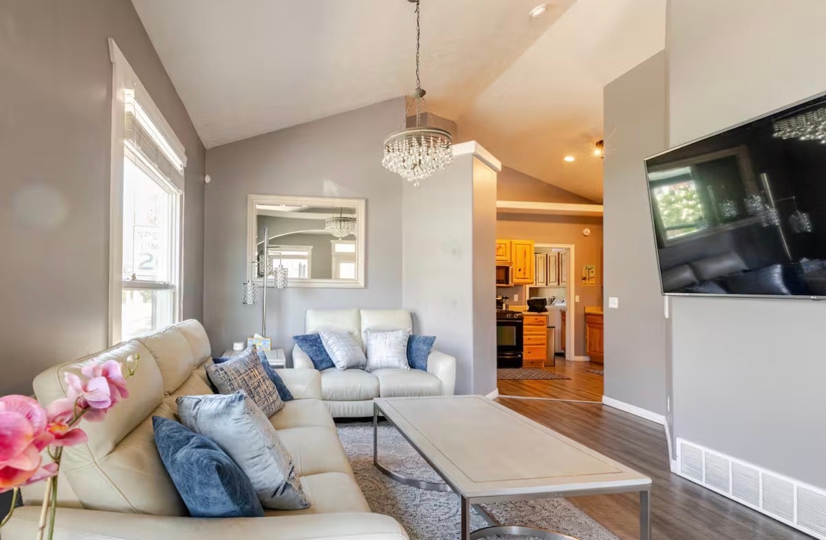 Open concept living room with designer furniture and lofted ceilings
