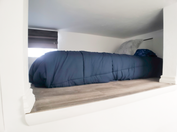 Built-in bed nook with navy blue bedding