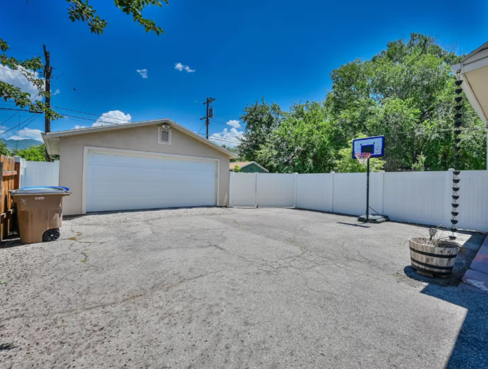 Spacious backyard with detached garage and basketball hoop