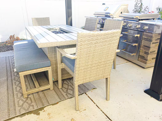 Wicker outdoor dining set with fire table and built-in grill station
