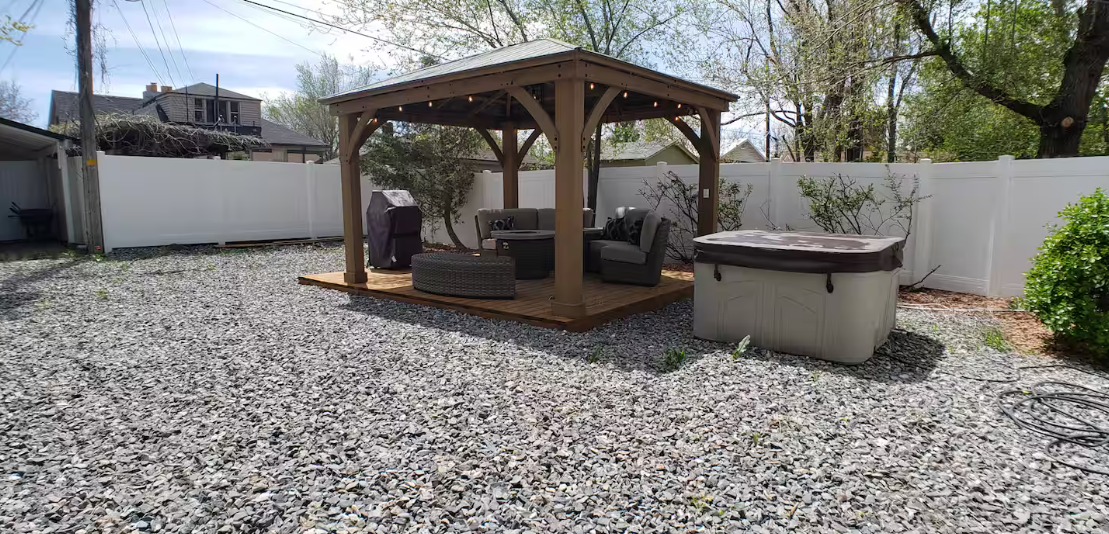 Backyard gazebo with hot tub and outdoor seating