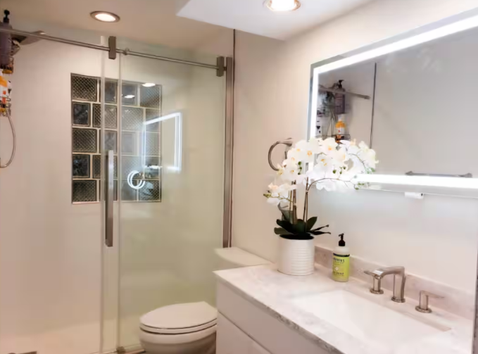 Updated bathroom with walk-in shower and LED mirror