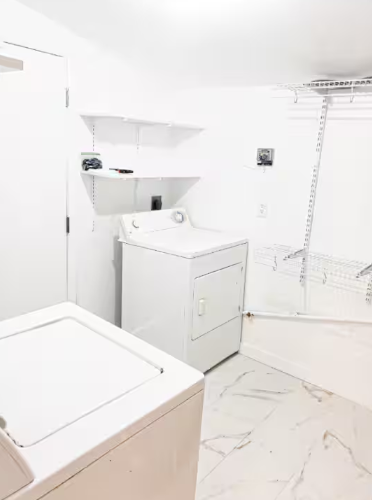 Laundry room with washer, dryer and wire shelving